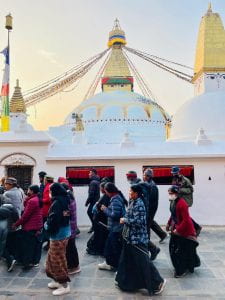 Worshippers walk in a clockwise direction around Boudhanath temple
